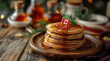 Stack of fluffy pancakes drizzled with golden maple syrup, decorated with a miniature Canadian flag photo
