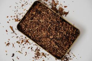fine tobacco in a gold box with a white background photo