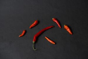 some red chillies on the dark table photo