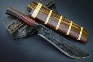 The Amulet black knife with tamarind core wood sheath is handmade in Thailand photo