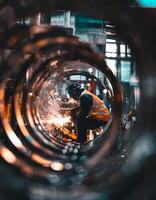 View from inside the steel pipe there was a welder at the end of the pipe photo