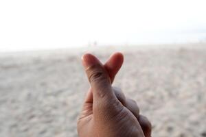 a person making a peace sign with their hand photo