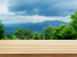 Wood table with blurred mountain and trees in summer photo