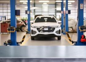 Metalic table for product display in front of blurred factory garage repair shop background photo