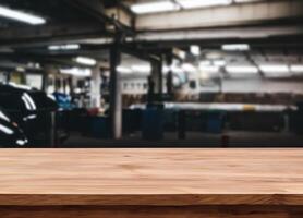 Wood table for product display in front of blurred factory garage photo