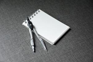 Blank notebook and dividers on dark table wooden pattern background,Blank black cover template with copy space for design,notebook isolated on dark background,concept of design and business. photo