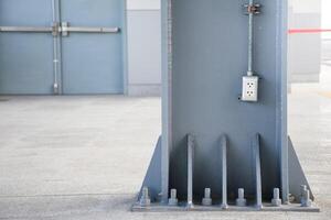 Socket or Receptacle stuck on the wall of a large scrap on the background of a building door for electrical systems concepts in buildings and homes. photo