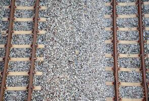 Double-track railway tracks on white gravel taking from top-view are public railway tracks in Bangkok. photo