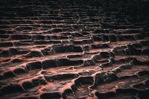 The amazing textures of rocks created by geological movements or lava deposits create beautiful stone formations with dark tones in the background. photo