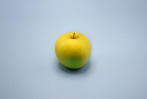 Fresh yellow apples mixed with green on gray isolated background studio shot for healthy fruit concept with fiber photo