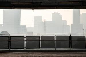Photographs from the building show views of Bangkok and buildings shrouded in fog and dust p.m 2.5. Panoramic of cityscape Bangkok with buildings and high voltage poles. photo