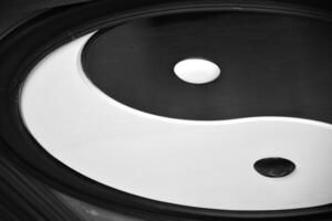 The yin and yang symbol which has a circle shape and black and white colors is a traditional Chinese symbol and represents good and evil. Render 3D white and black colors of yin and yang. photo