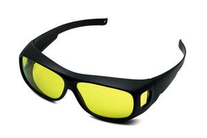 Side view of cool black sports sunglasses with yellow lenses for filtering light on white isolated background studio shots. Glasses for product design on white background. photo