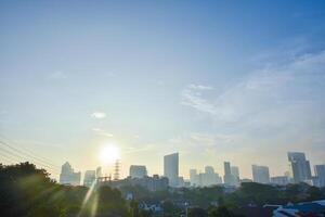 Beautiful sunlight sunset in the evening and view of dowtntown and the Thai capital with residential houses and modern buildings on a skyline background and a clear sky. photo