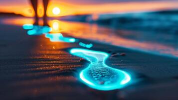 Footprints in the Sand at Sunset With Glowing Blue Light Effect. photo