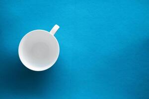 White tableware crockery set, empty cup on blue flatlay background photo