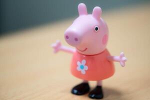 Peppy Pig toy figurine on wooden surface photo