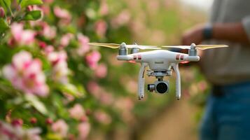 Young farmer utilizing AI driven drone for pest surveillance in a colorful blooming apple orchard photo