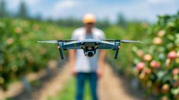 Young farmer utilizing AI driven drone for pest surveillance in a colorful blooming apple orchard photo