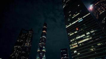 Dramatic night skyline with illuminated skyscrapers against a dark sky, conveying concepts of urbanization and modern architecture, suitable for business and travel 15 dec 2023, Shanghai, China photo