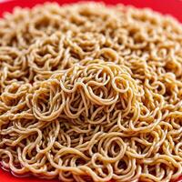 Ramen noodles against a bright red backdrop photo