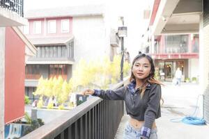 Asian women do freestyle hip hop and breakdancing in a public space in the middle of the city. With a cheerful and happy attitude photo