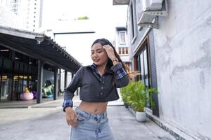Asian women do freestyle hip hop and breakdancing in a public space in the middle of the city. With a cheerful and happy attitude photo