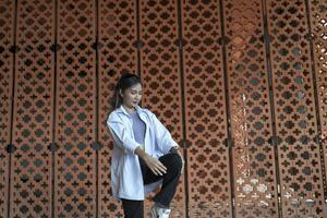 Asian women do freestyle hip hop and breakdancing in a public space in the middle of the city. With a cheerful and happy attitude photo