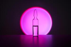 Several ampoules for injection with medicines on a lilac background. photo
