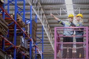 workers man and woman using a hydraulic scissor lift to check stock near the shelves warehouse. industry factory warehouse. Worker Screening Package In Warehouse. photo