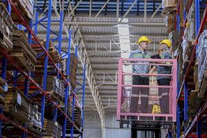 workers man and woman using a hydraulic scissor lift to check stock near the shelves warehouse. industry factory warehouse. Worker Screening Package In Warehouse. photo