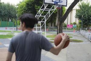 Men take a walk to relax after playing basketball in a public area, having fun and practicing at the same time. photo