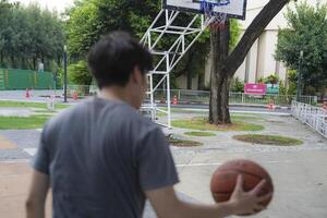 Men take a walk to relax after playing basketball in a public area, having fun and practicing at the same time. photo