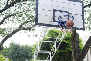 Men take a walk to relax after playing basketball in a public area, having fun and practicing at the same time. photo