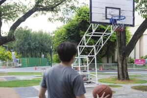 Men take a walk to relax after playing basketball in a public area, having fun and practicing at the same time. photo