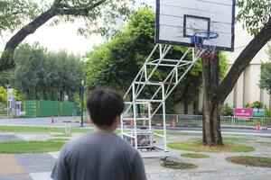 Men take a walk to relax after playing basketball in a public area, having fun and practicing at the same time. photo