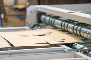 Cardboard on a machine production line, texture, background for graphics It is factory made cardboard waiting to be packed. photo