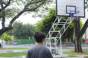 Men take a walk to relax after playing basketball in a public area, having fun and practicing at the same time. photo