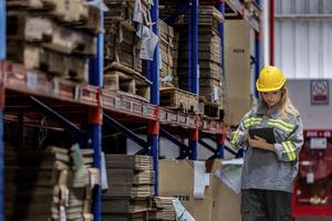 woman worker walking and checking stock items for shipping. Female inspecting the store factory. Logistics employees holding folders at on site warehouse area for shipping transportation. photo