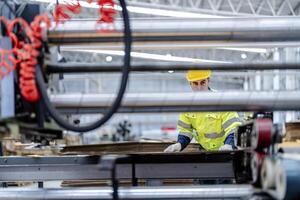 technician engineers checking the process on Heavy machine. mechanical engineering team production. Industry manufacturing. Worker holding tablet and folde. High technology production. photo
