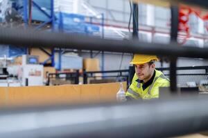 technician engineers checking the process on Heavy machine. mechanical engineering team production. Industry manufacturing. Worker holding tablet and folde. High technology production. photo