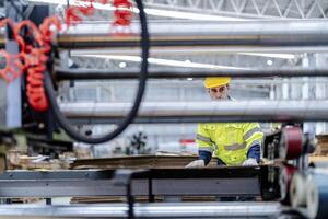technician engineers checking the process on Heavy machine. mechanical engineering team production. Industry manufacturing. Worker holding tablet and folde. High technology production. photo