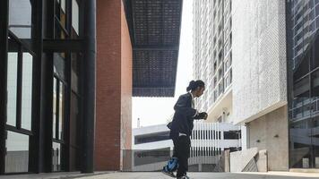 ASian man is dancing in hip hop style at outdoor space. Professional solo dancer is performing in public area. photo