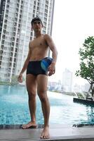 Asian men practicing swimming and preparing to play water polo and stretching and resting for water sports. photo