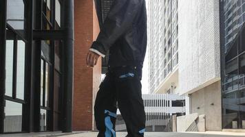ASian man is dancing in hip hop style at outdoor space. Professional solo dancer is performing in public area. photo