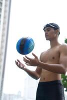 Asian men practicing swimming and preparing to play water polo and stretching and resting for water sports. photo