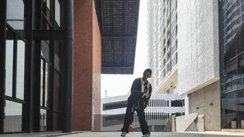 ASian man is dancing in hip hop style at outdoor space. Professional solo dancer is performing in public area. photo