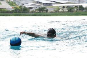 Asian men practicing swimming and preparing to play water polo and stretching and resting for water sports. photo