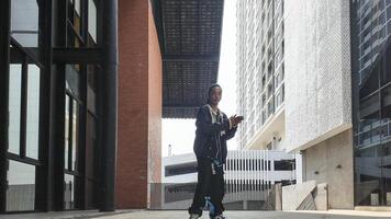 ASian man is dancing in hip hop style at outdoor space. Professional solo dancer is performing in public area. photo