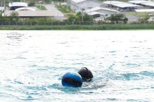 Asian men practicing swimming and preparing to play water polo and stretching and resting for water sports. photo